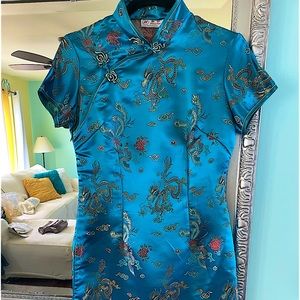 Brilliant turquoise cocktail dress. Embroidered frog closures at neck